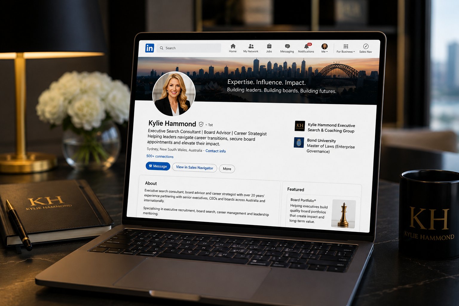 Kylie Hammond LinkedIn profile on a laptop with KH notebook and mug